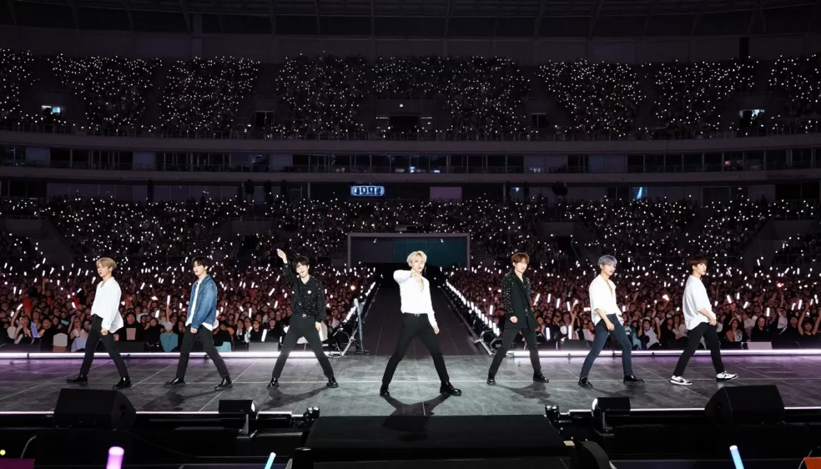 BTS performing at a sold-out stadium concert, positioned at #1 in top 10 kpop groups 2026
