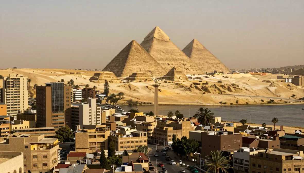 Cairo skyline with the Nile River and pyramids visible in the distance, showing Egypt's ancient and modern capital