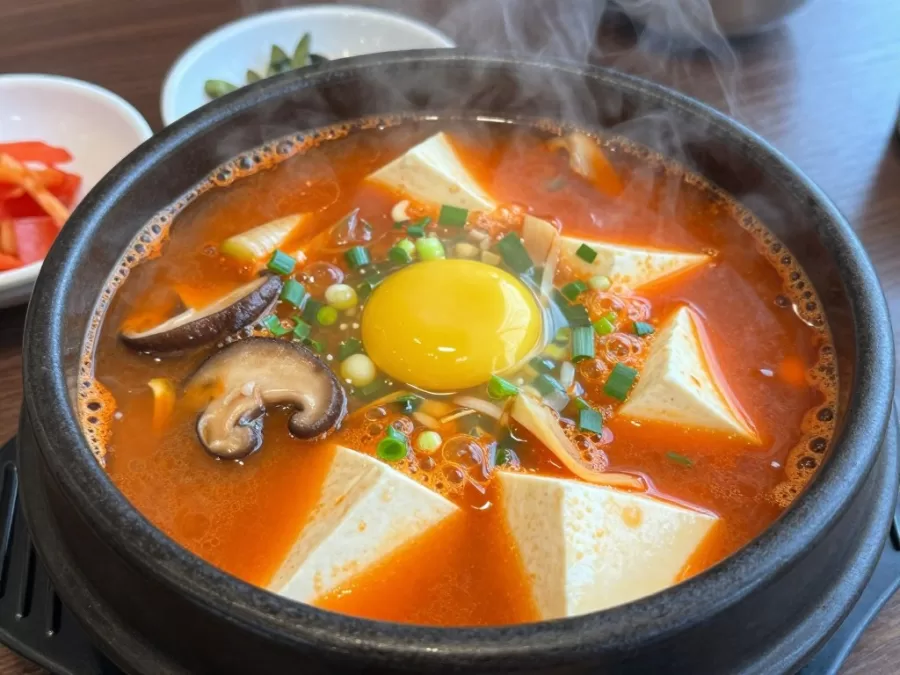 Sundubu Jjigae soft tofu stew bubbling in a stone pot