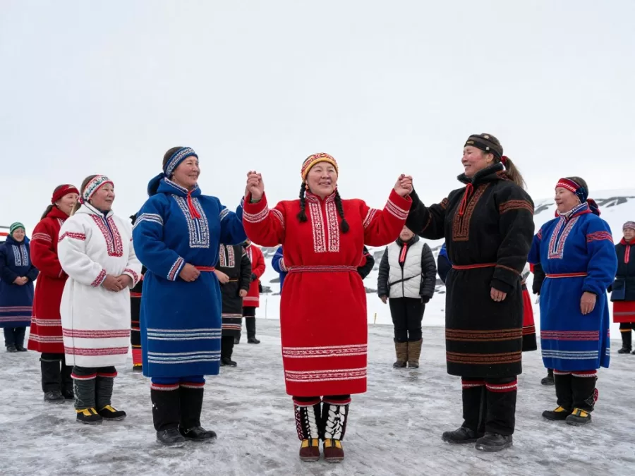 Traditional Greenlandic cultural celebration with people in colorful national costumes