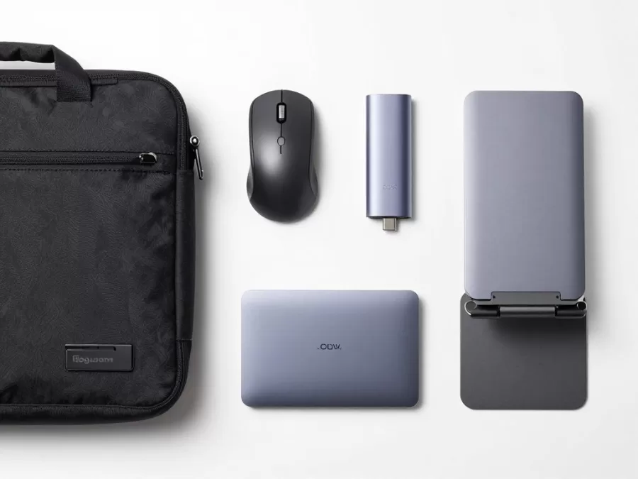 laptop accessories laid out including bag, mouse, charger