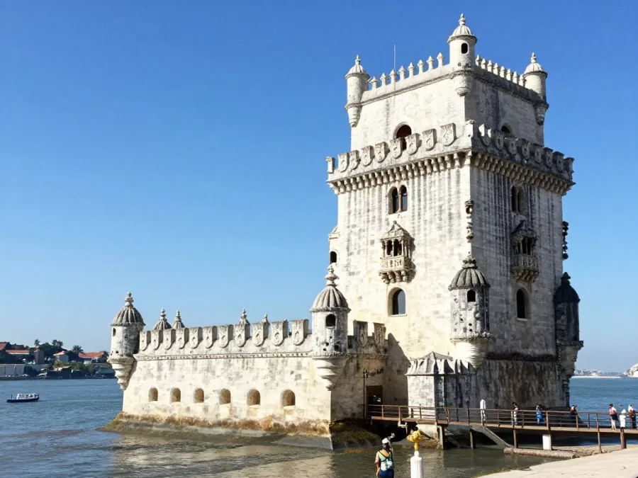 Belem Tower on Tagus River in Lisbon Portugal with tourists during summer