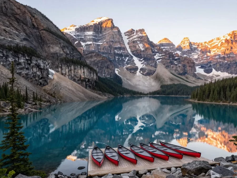 Moraine Lake in Banff with ten peaks reflected in turquoise water and canoes at the dock
