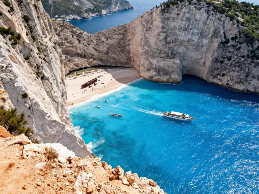 Navagio Beach cliff view aerial perspective tourists boats