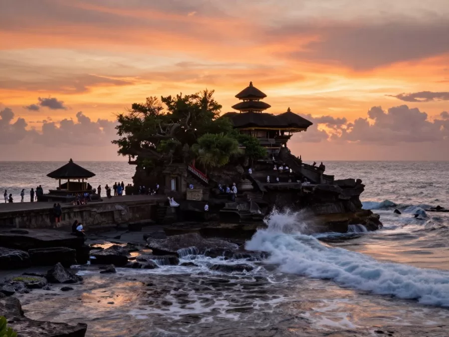 Tanah Lot temple on rocky outcrop surrounded by ocean waves at sunset