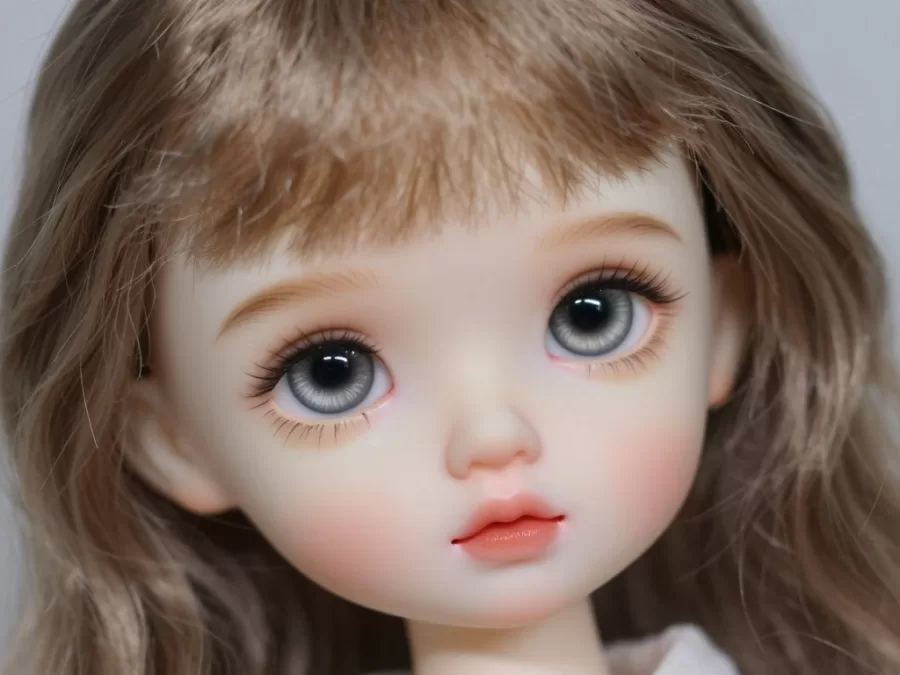 Close-up of Eloise doll showing hand-painted facial features and hair details