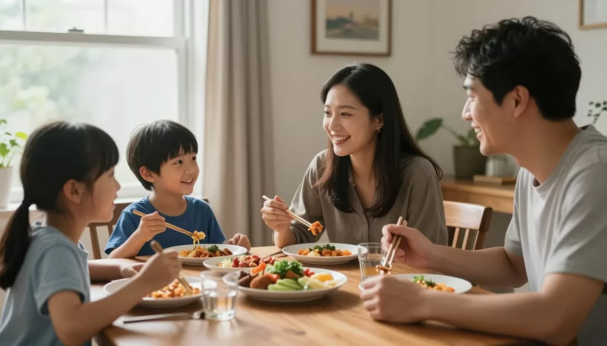 Happy family of four eating dinner together
