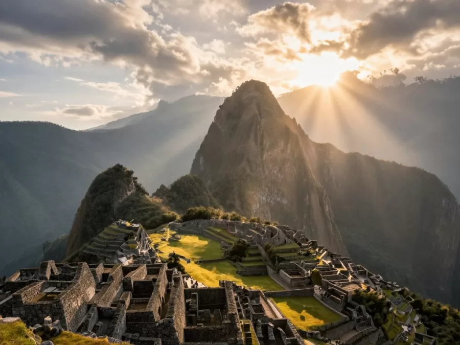 Machu Picchu sunrise with light rays over mountains