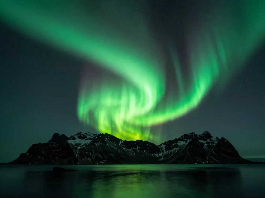 Northern lights over Iceland landscape with mountains