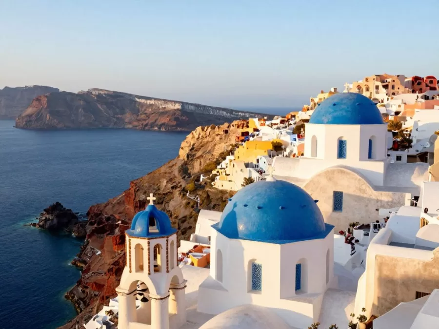 Santorini Greece white buildings overlooking turquoise Aegean Sea