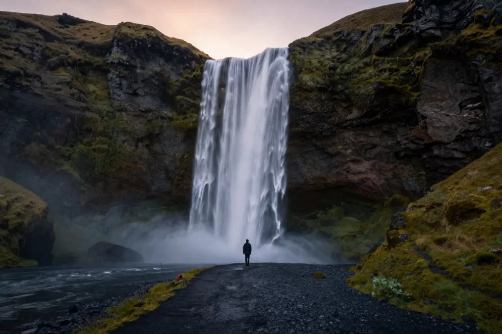 Seljalandsfoss waterfall with person behind water curtain