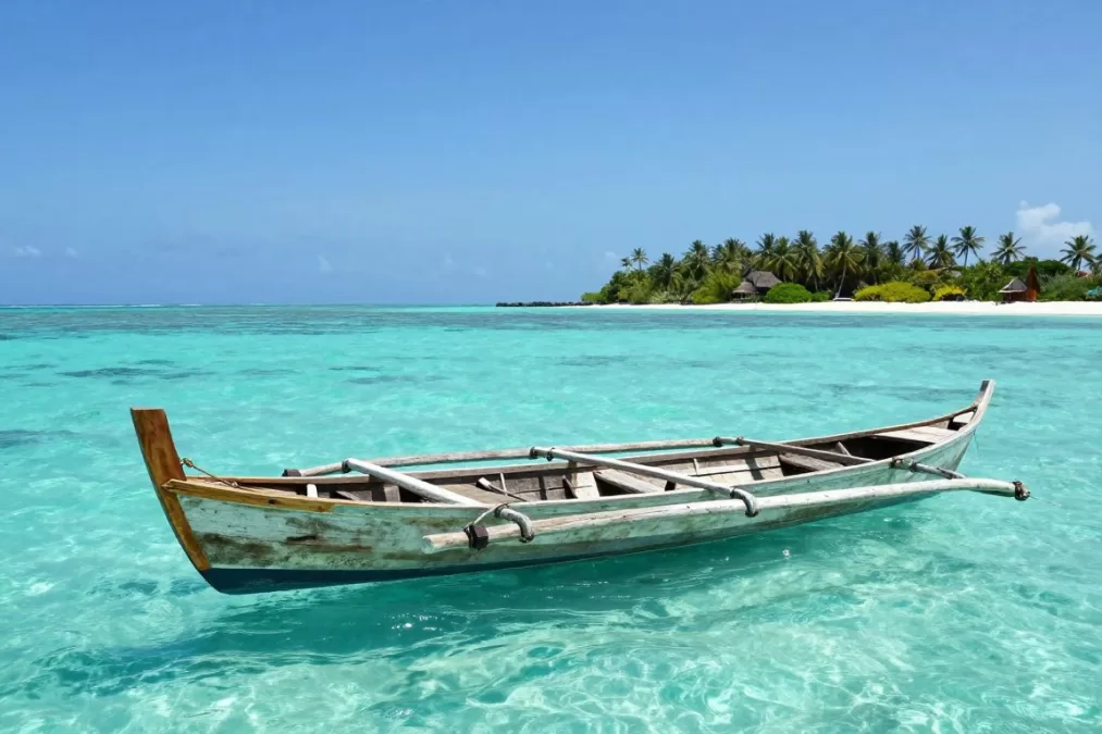 Traditional Maldivian dhoni boat on turquoise water
