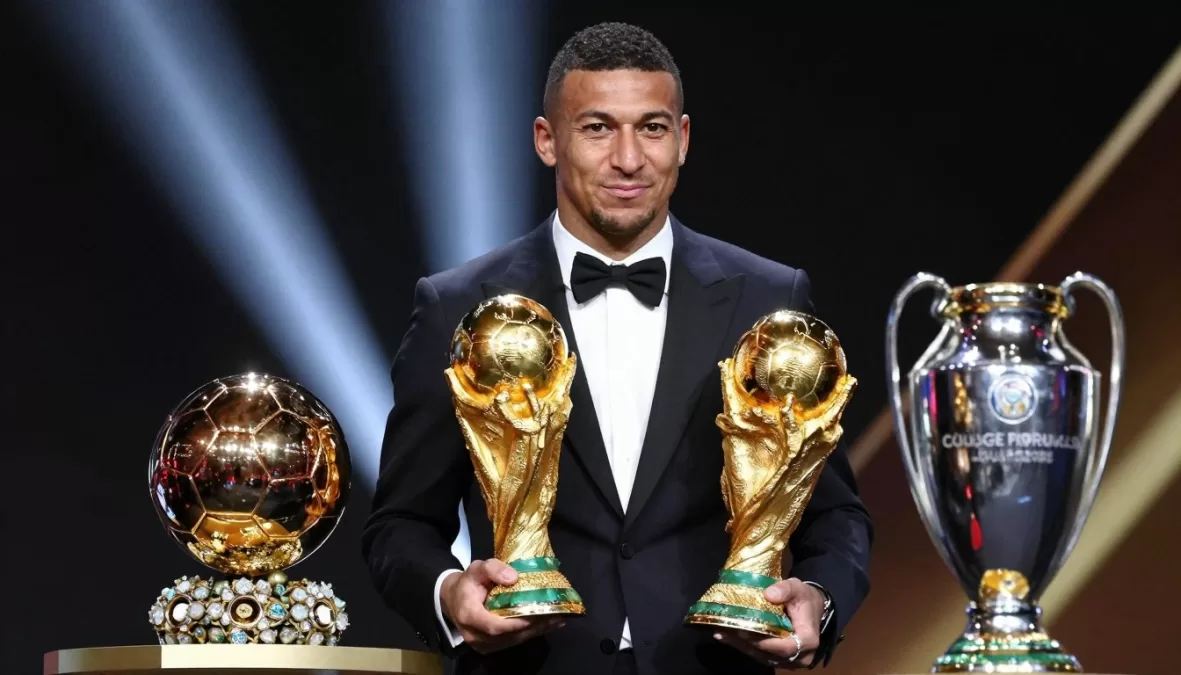 football player holding multiple trophies and awards