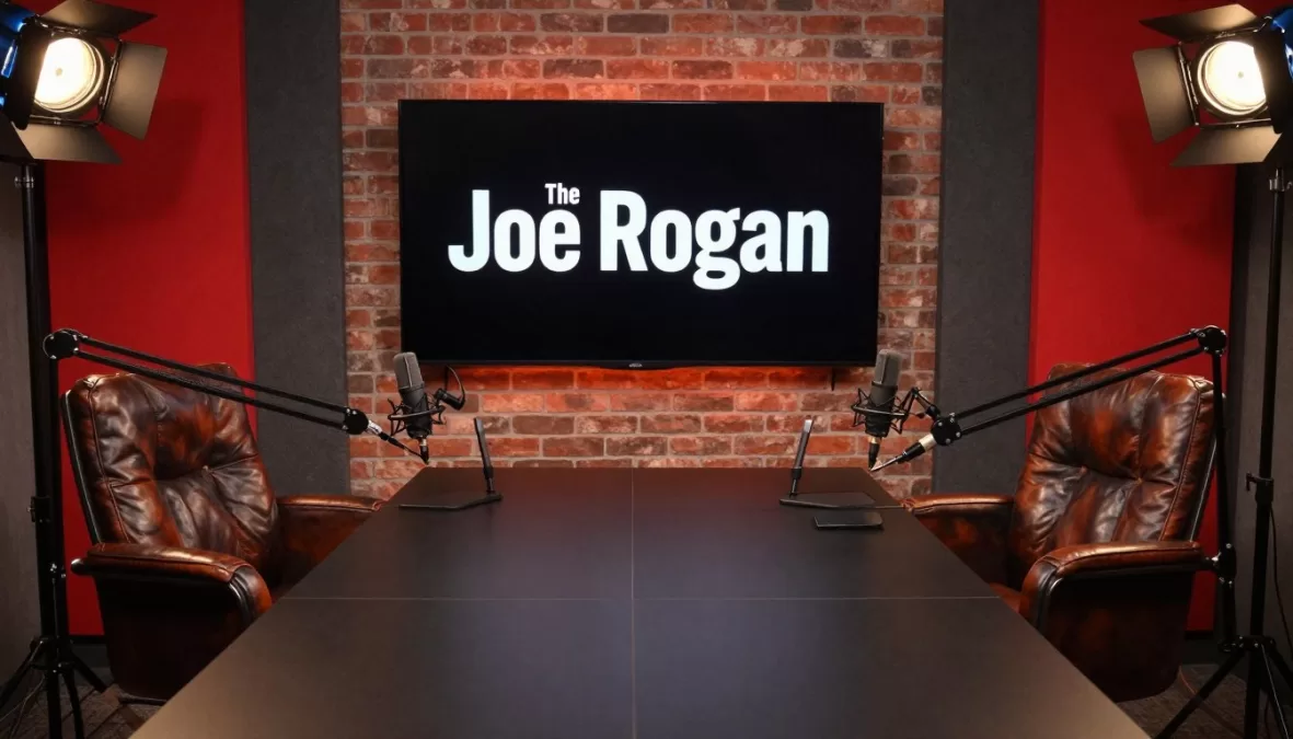 joe rogan experience podcast studio with iconic red chairs and microphone setup