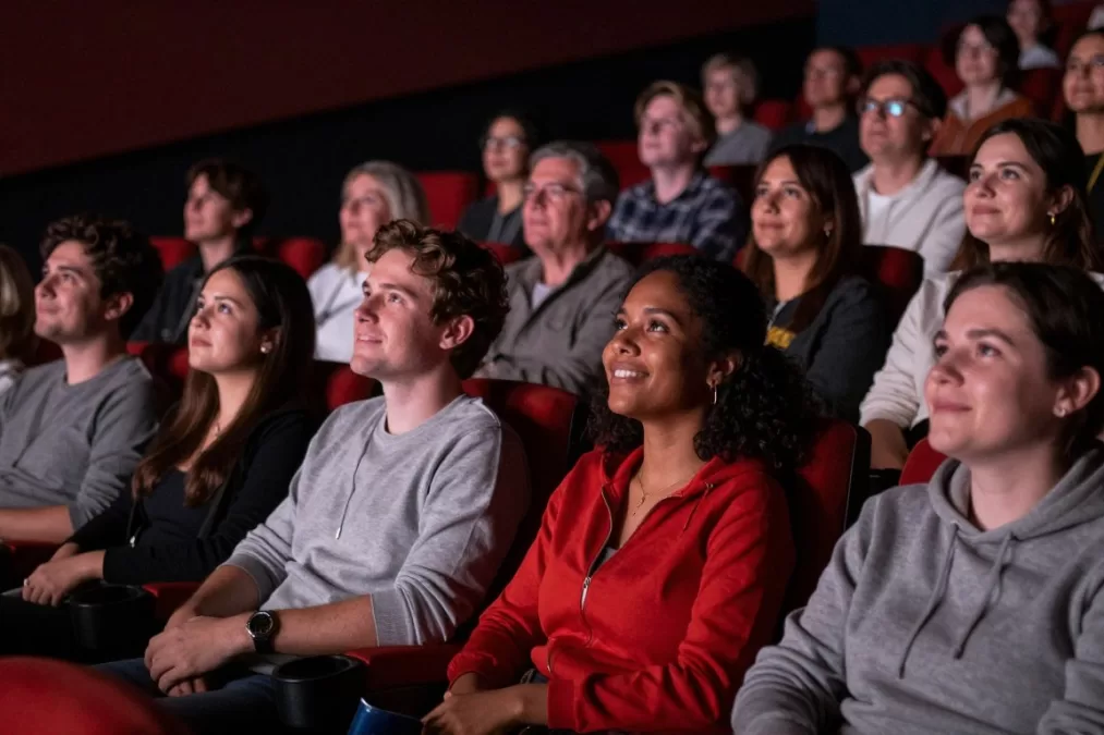Audience of diverse fans watching superhero movies together enjoying the experience