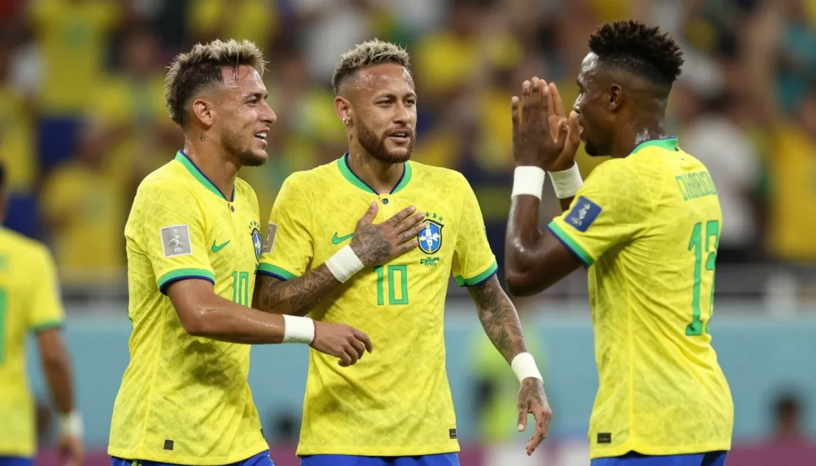 Brazil national soccer team players in yellow jerseys celebrating world cup goal
