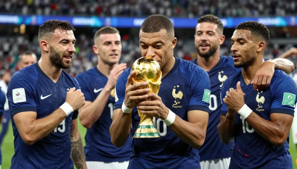 France national soccer team celebrating with world cup trophy and players in blue jerseys