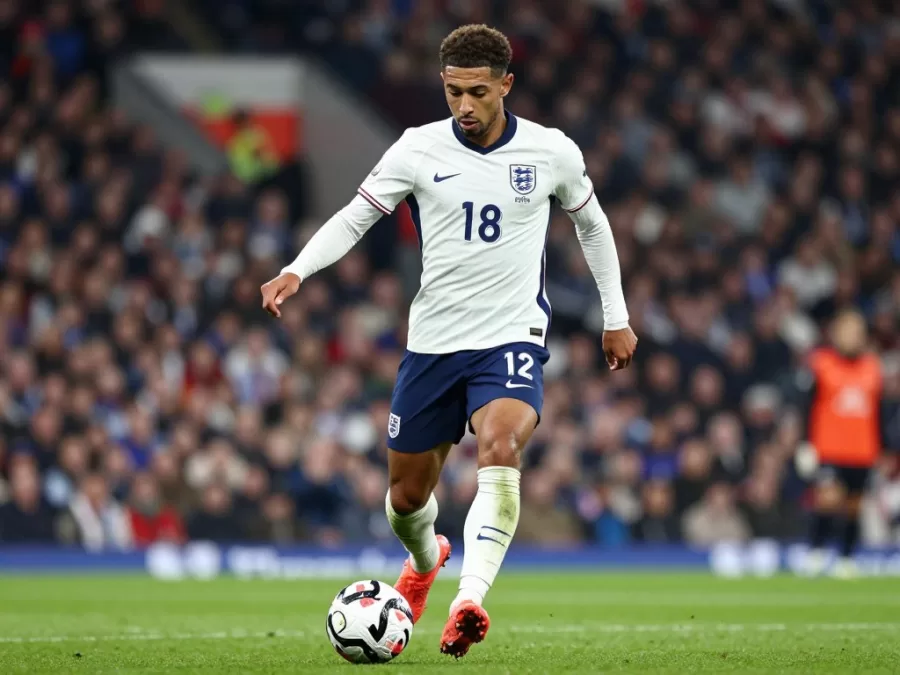 Jude Bellingham controlling soccer ball in England white jersey midfield action