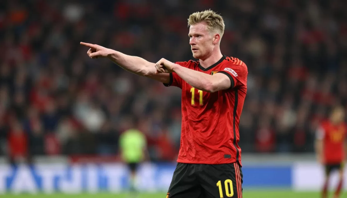Kevin De Bruyne passing soccer ball in Belgium red jersey