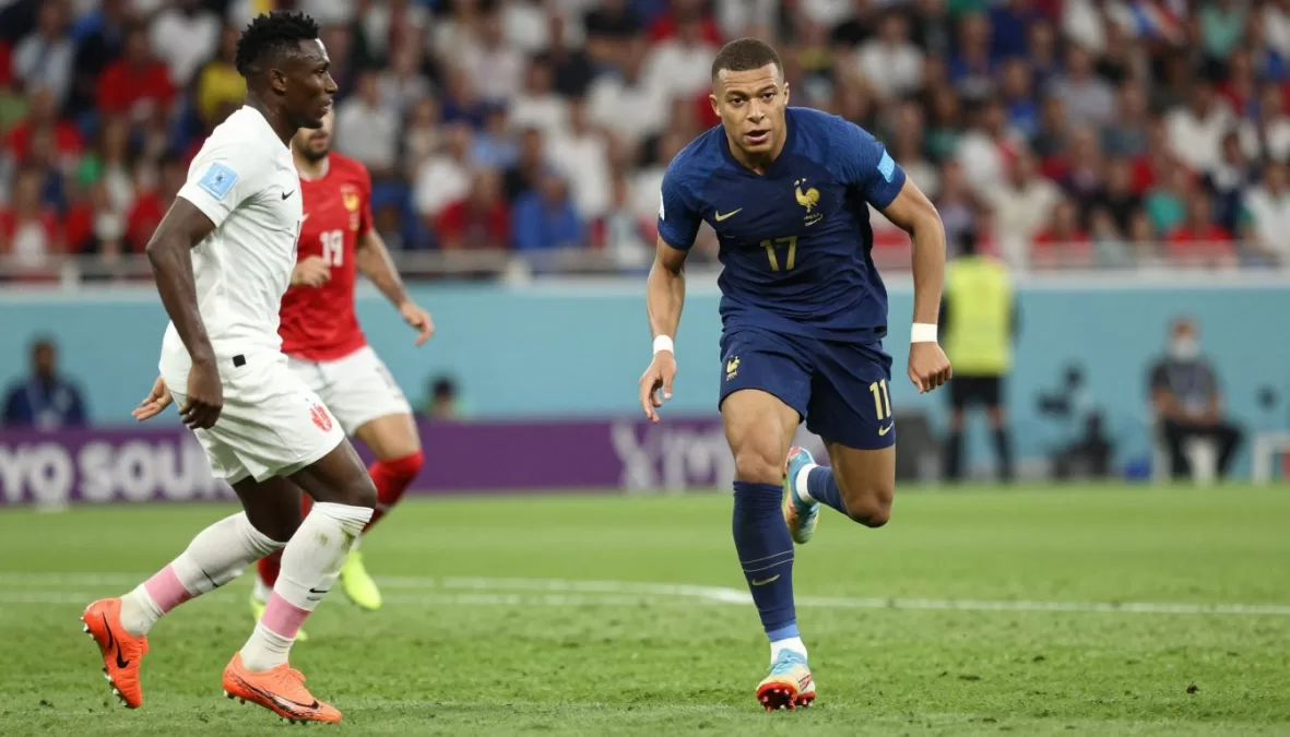 Kylian Mbappe dribbling soccer ball in France national team uniform during world cup game