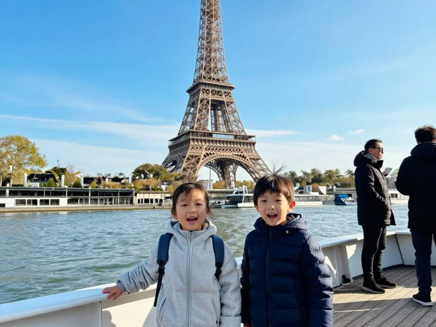Children on open deck of Seine cruise boat with Eiffel Tower in the background