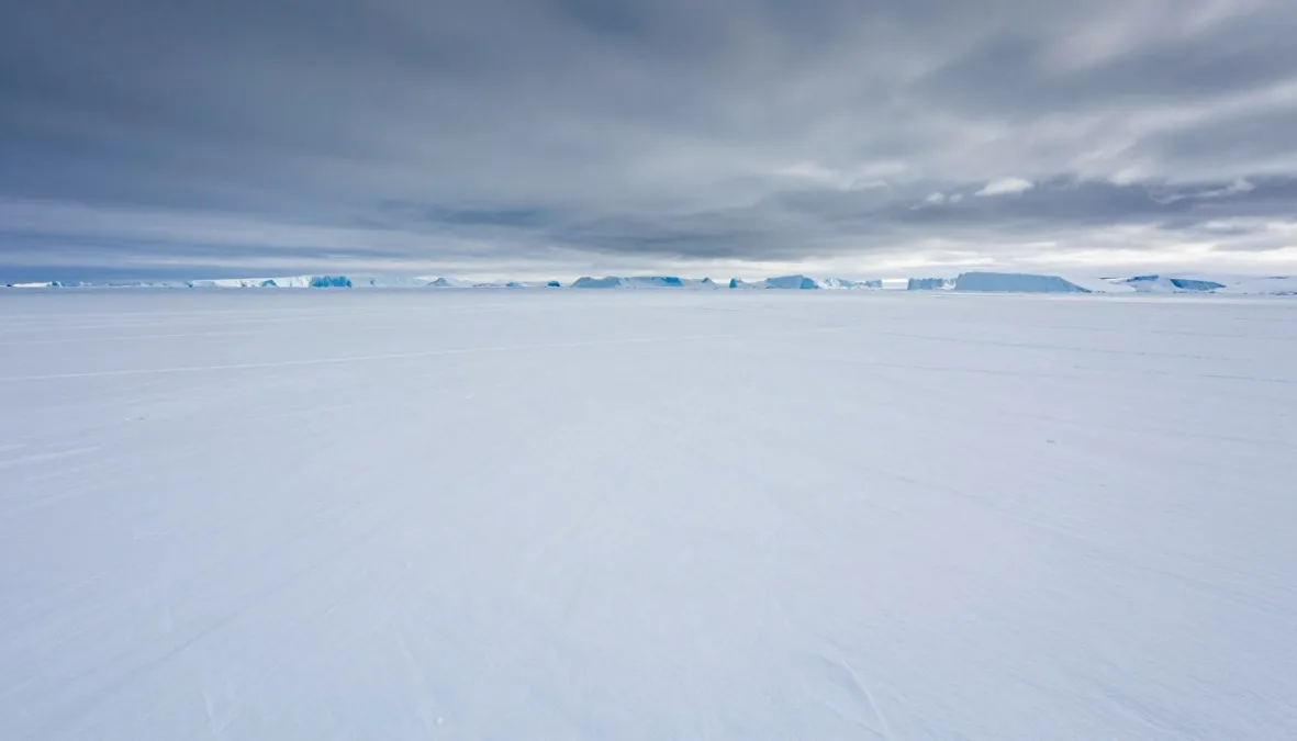 Greenland's massive ice sheet stretching endlessly in silent white expanse