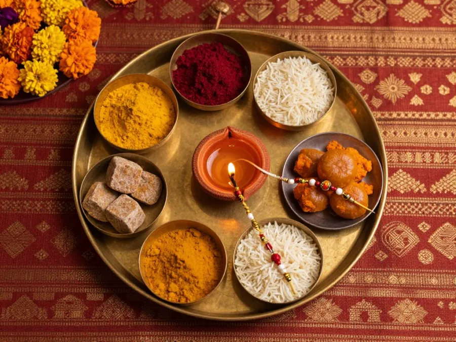 Traditional brass pooja thali with roli chawal and diya