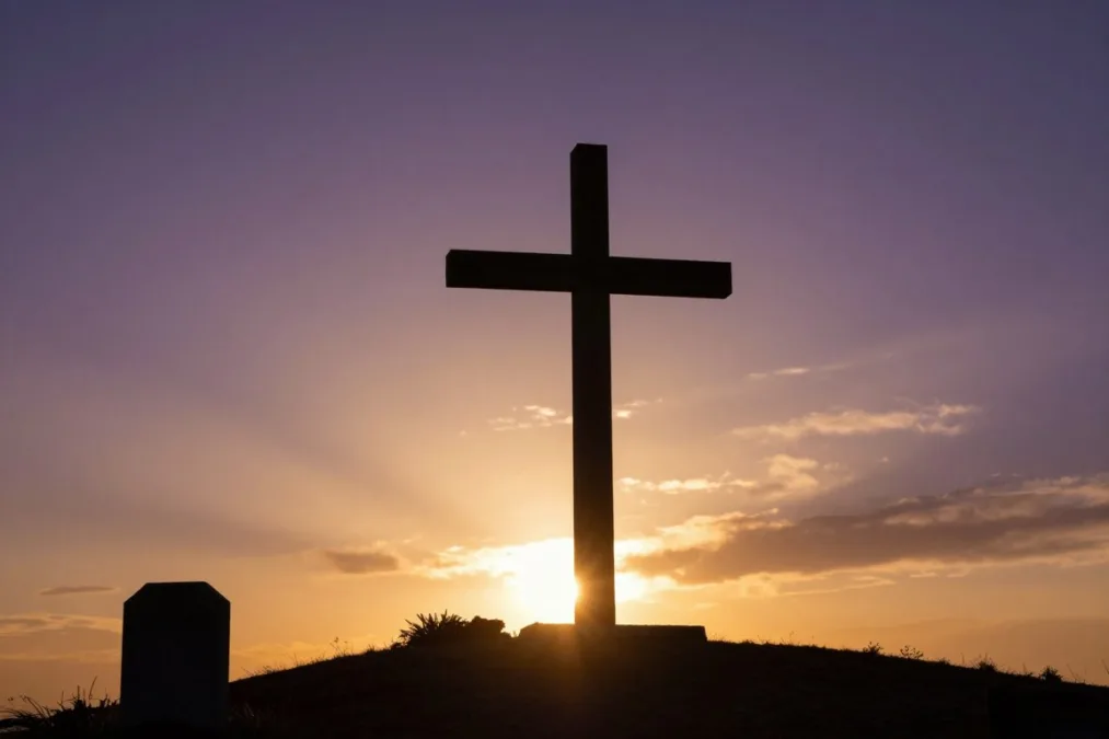 cross silhouette at sunset representing in christ alone worship song